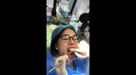 Nervous patient jokingly bites dentist's finger