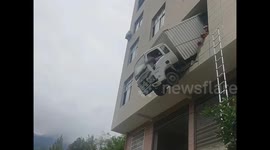 You can't park there! Truck left dangling from second-floor after terrifying crash in China