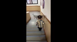 Little girl’s braids bounce humorously on stairs in Henan, China