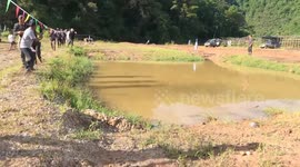 Modified off-road car drives through muddy pool during race