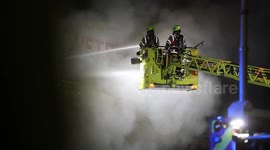 Smoke and Flames rise as over 70 firefighters tackle a blaze at an industrial unit in Greenwich, South East London