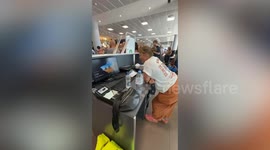 Mum fed up of airport chaos takes control of tannoy and helps board eight planes