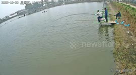 Fisherman falls into the water after strong catch in Beijing, China