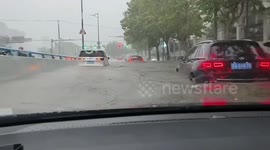 Cars struggle through flooded highway after heavy rain in Shanghai, China
