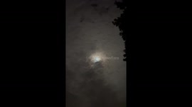 Bright moonlight shines through clouds in Belwood, Canada