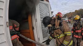 firefighters enter a burning building during  training