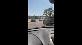 Car drives in reverse on highway in Manhattan, New York, USA