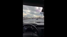 Scooter rider overtakes BMW at high speed on highway in Moscow, Russia
