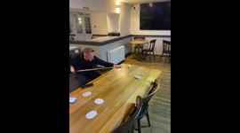 Man performs incredible billiard trick shot from dining table in Cardiff, UK