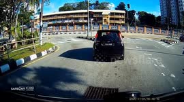 Sinkhole opens up while cars are stopped at lights on road in Malaysia