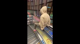 Person slides down escalator handrail in Guangdong, China