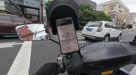 Electric bike falls while crossing pedestrian lane in Shanghai, China