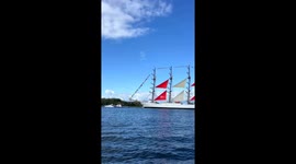 Sail Amsterdam 2025 - The tall ship moves with quiet dignity along the river’s course