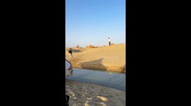 Man trips and falls into river while running in Xinjiang, China