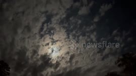 Moon peeking through clouds in Gray, Kentucky, USA