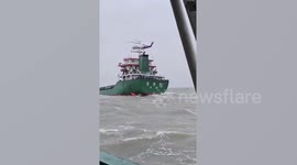 Helicopter saves sailors from sinking cargo ship in rough waters