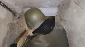 Footage filmed in Bakhmut on November 30, 2022, shows volunteers entering a basement shelter where a local resident lived with his dog, which recently died. Close-up faces are visible.