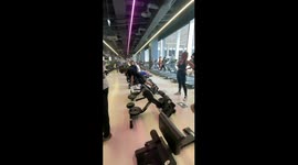 Guy Steps Backwards Onto Woman's Hair At Gym