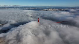 Fog blankets San Francisco Golden Gate Bridge, creating mesmerizing scene