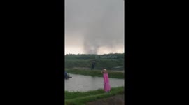 Tornado forms over a field as people flee in Hainan, China