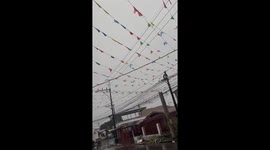 Strong winds tear down fiesta decorations in San Pedro, Laguna, Philippines