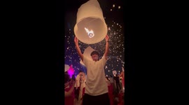 Lantern release goes wrong when it lands on another person's head