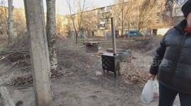 Volunteers deliver heating stoves to residents in a heavily–shelled district of Bakhmut, Ukraine, as locals describe recent strikes and low population remaining.
