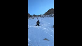 Hiker intercepts friend sliding uncontrollably down snow mountain in Ningxia, China