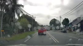 Shocking moment electricity post falls onto passing cars