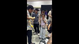 Brave little visitors have Burmese python draped over their shoulders