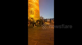 Man spins prayer wheel for good luck but his pet dog frantically tries to stop him