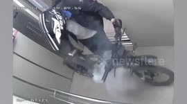 Cyclist drags fiery e-bike from lift after it suddenly bursts into flames