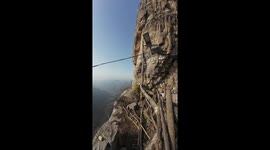Daring walk along cliff edge of “One Meter Cliff,” Hebei, China