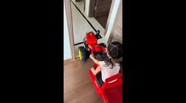 Young girl crashes toy tractor into cabinet in Guangdong, China