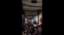 Man slips on wet road during rainfall in Surabaya, Indonesia