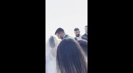 Best Man Fights To Not Laugh While Priest Sings in Prayer