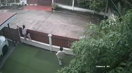 Automatic house gate traps girl climbing on fence