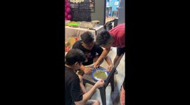 Lads pick mung beans with chopsticks for party game