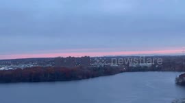 Peaceful sunrise reflected over a calm lake in Cambridge, USA