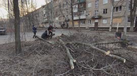 Bakhmut. Locals cut firewood. Preparing for winter. Volunteers talk with residents. Conflict zone. Ukraine.