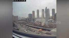 Building collapses sending debris crashing onto dozens of cars below