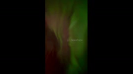 Aurora borealis paints night sky over Big Marine Lake in Minnesota, USA