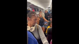 RAW FOOTAGE- 'Karen' has fierce argument with plane passengers after rushing for exit