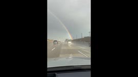 Full rainbow arches across the sky in Anaheim, California, USA