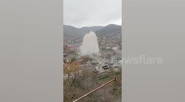 Burst pipe sends water rocketing into sky in middle of busy street