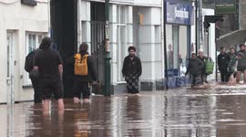 Supermarket workers wade through floodwater after being trapped in store overnight in Wales