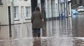 STORM CLAUDIA- MONMOUTH TOWN RESIDENT WADES THROUGH FLOODWATERS TO SEE DEVASTATION