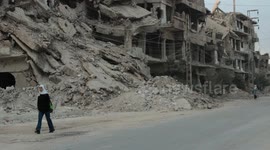 Syrian children walk to school among destroyed buildings in Daraya, one of hardest hit region by war