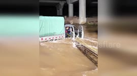 China: Truck Trapped In Raging Flood As Firefighters Battle To Save Three Lives