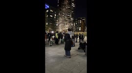 Pro Palestinian supporters gather outside the American Embassy in London as an activist delivers a short speech.